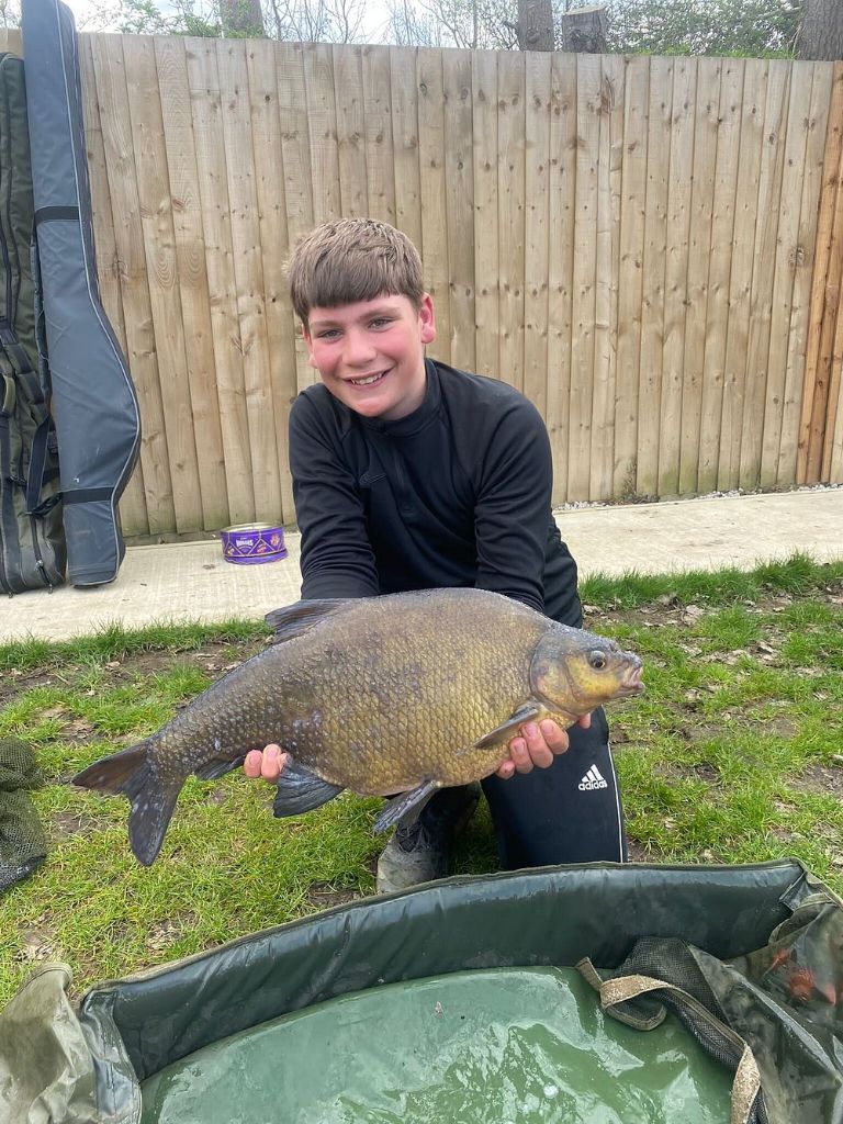 Boy with large carp catch